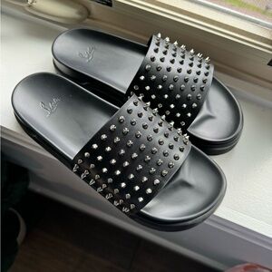 Lightly used pair of Christian Louboutin “Pool Fun” black spike slides in size46